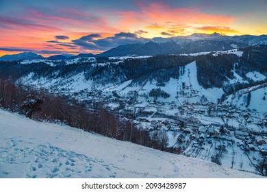 Amazing winter dawn scenery with snowy mountains. Picturesque sunrise and snowy mountain ridge in background, Bucegi mountains, Carpathians, Romania, Europe