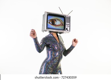 amazing woman dancing and posing with a television as a head. the tv has a large eye on it