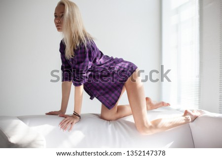 Amazing young blond girl posing for photo in studio