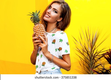 Amazing Young Woman With Fresh Fruits Posing Outdoor,summer Concept Image, Smiling Funny,happy Summer Mood, Yellow Wall,cool T-shirt With Fruit Design,summer Style Outfit Women,tan Skin,pineapple 