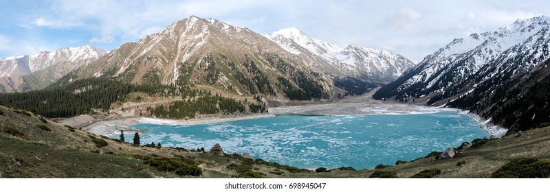 Amazingly blue Big Almaty lake covered with ice