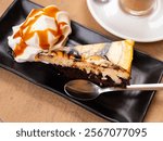 Amazingly delicious sweet cheesecake with brownies and caramel ice cream