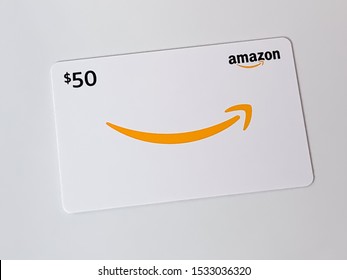Amazon gift card for $50 laying on the table. Amazon gift card can be used on Amazon.com to make online purchases. Brooklyn, New York, USA October 1, 2019.