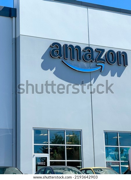Amazon logo and Smile symbol at\
their corporate office building. Everett, WA, USA - August\
2022