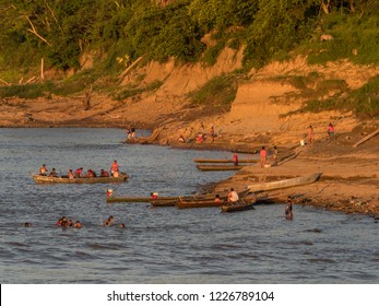 Amazon River, Peru - Sep 24, 2018: Local People On Bank Of The Amazon River During The Low Water Season. Sunset View From  The Deck Of A Cargo Boat Amazonia. Peru. South America.