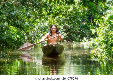 Amazon Tribe Brazil Indian Ecuador Indigenous Native Village Forest People Culture Indigenous Grown Man On Ordinary Wooden Boat Jagged From A Single Timber Cruising Misty Waters Of Ecuadorian Amazonia