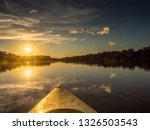 Amazonia. Sunset view seen from the kayak. Coati Lagoon near the Javari River, the tributary of the Amazon River. Selva on the border of Brazil and Peru. South America.