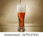 Amber Beer. Glass of fresh and cold beer. Pouring craft beer.  Shallow depth of field
