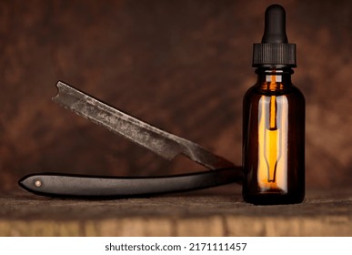 Amber Bottle Of Beard Oil, An Old Razor. Vintage Style Mockup Oil Beard. MOCK-UP