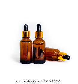 Amber Bottle for essential oils and cosmetic products. Mock Up. Three Glass bottle on white background. A dropper, a bottle with a sprayer. Size 30ml.