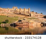 Amber Fort illuminated by warm light of the rising sun and reflected in the lake. Famous Rajasthan landmark located nearby Jaipur city in north-western India.