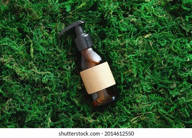 Amber Glass Cosmetic Bottle With Soap Gel Lotion On Moss Background. SPA Beauty Products Packaging Design, Branding.