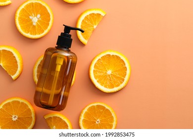 Amber glass shampoo bottles with sliced orange top view. SPA natural fruit cosmetics. - Powered by Shutterstock