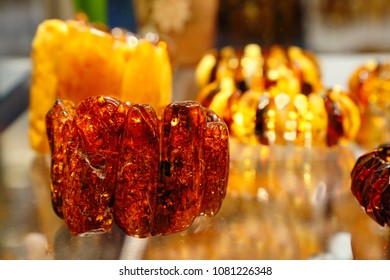 Amber products in the storefront. Bracelet made from natural ancient resin. Amber texture. Sunny stone as the main background for advertising jewelry. Jewelry made of amber natural mineral.