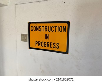 An Amber Sign Warning People That Construction Work Is In Progress In A Hospital Building In South Africa.