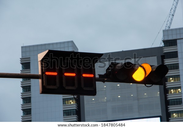 Amber traffic light, Orange\
light appeared. Which was hanging horizontally. The traffic light\
is about to change to red light and the car will have to\
stop.