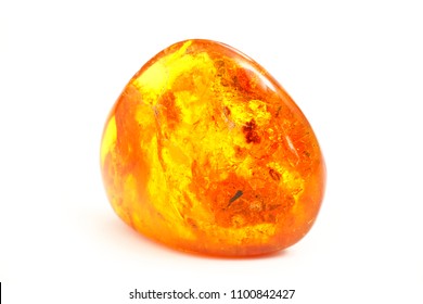 Amber. Transparent beautiful and bright piece of yellow amber amber on a white background. A sunny stone with a bright light inside. Natural material for jewelers. Sun Stone. Frozen resin