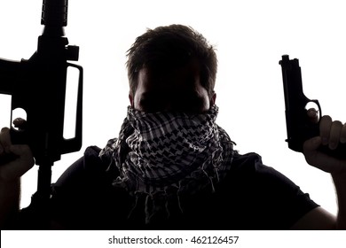 Ambiguous Silhouette Of A Terrorist Or A Soldier With A Rifle And A Handgun.  The Image Depicts Home Grown Terrorist Or An Anonymous Special Operations Agent.