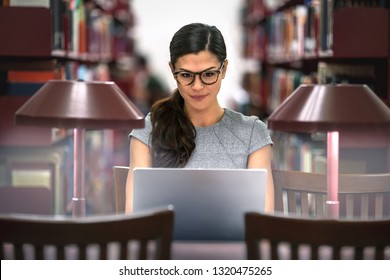 Ambitious, determined, and devoted student studying at the library, driven go getter discipline