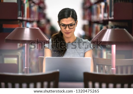 Ambitious, determined, and devoted student studying at the library, driven go getter discipline