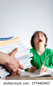 Ambitious Parenting With High Academic Achievement Expectations From Kids Concept. A Mother Is Bringing A Pile Of Test Prep Books To Her Bored, Tired Kid Who Is Crying And Protesting During Homework