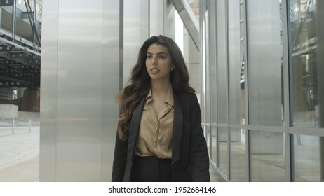 Ambitious Successful Hispanic Young Adult Business Woman Walking Outside Office In City Wearing Suit