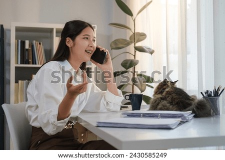 Ambitious young business woman having phone conversation for work discussion and planning.