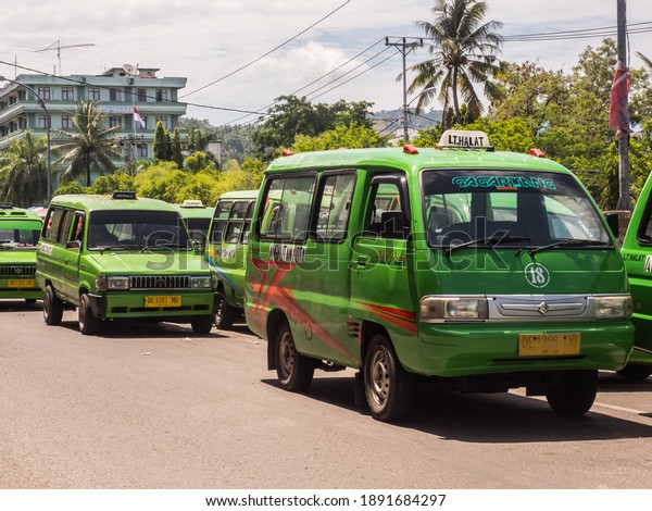 Ambon,\
Indonesia - February 2018: Angkot, Public transport vehicles in\
urban traffic that is colorful buses on Ambon island. Each color\
goes to a different part of the island.\
Asia.