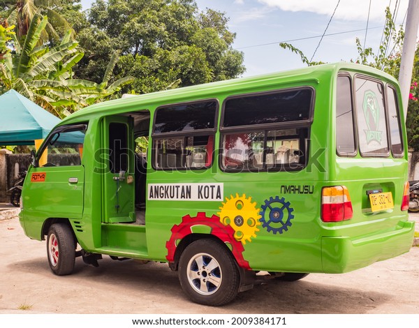 Ambon,\
Indonesia - February 2018: Angkot, Public transport vehicles in\
urban traffic that is colorful buses on Ambon island. Each color\
goes to a different part of the island.\
Asia.