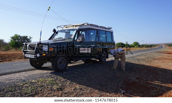 Amboseli - Nairobi, Kenya, July, 01, 2019:\
repairing a 4x4 vehicle for safari on the roadside of Amboseli to\
Nairobi in Kenya