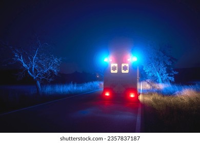 Ambulance car of emergency medical service on road at night. Themes rescue, urgency and health care. 

