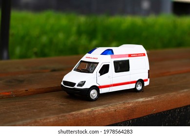 Ambulance car on the asphalt among the trees close up - Powered by Shutterstock