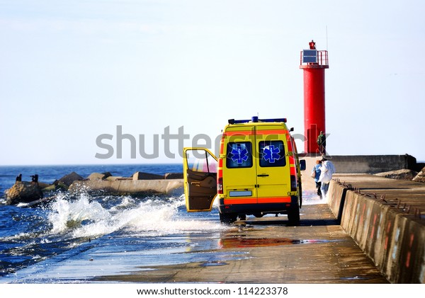 ambulance car rescuing people at the sea shore\
during storm