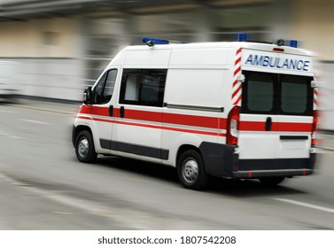 An Ambulance Is Driving Down The Street