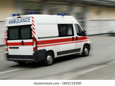 An Ambulance Is Driving Down The Street