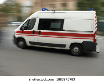 An Ambulance Is Driving Down The Street