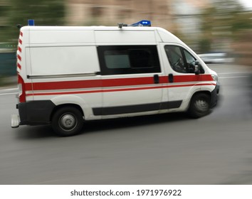 An Ambulance Is Driving Down The Street