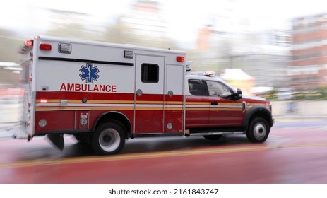 An Ambulance Is Driving Down The Street