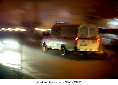 Ambulance In Motion Driving Down The Road At Night. Intentional Motion Blur