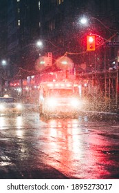 Ambulance On A Rainy Night In The City. Flashing Lights Emergency Vehicle In Toronto