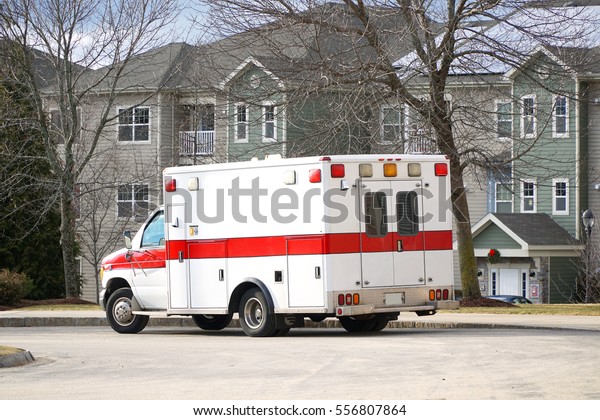 ambulance parked\
in the street in residential\
area