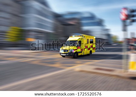 Ambulance responding to emergency call driving fast on street