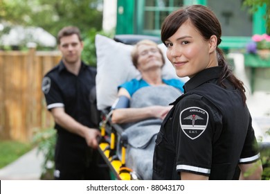 Ambulance Worker Portrait With Stretcher, Paitient And Co-worker