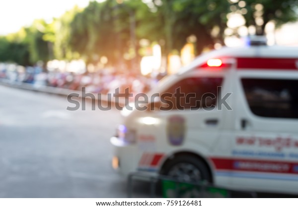 Ambulances with\
emergency light at city hospital ,blurred for\
background.\
Defocused of ambulances\
.
