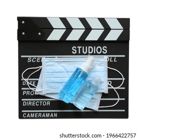 Amedical Face Mask And Hand Sanitizer On Clapperboard Or Film Slate On White Background