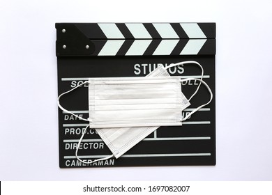 Amedical Face Mask On Clapperboard Or Film Slate On White Background