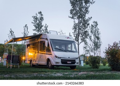 Ameglia, La Spezia, Italy - July 5, 2019: Malibu Carthago Mobile Home Parked In River Village Camping. Evening