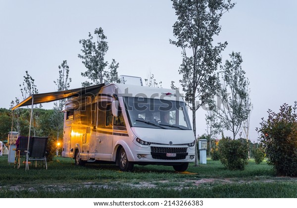 Ameglia, La Spezia,\
Italy - july 5, 2019: Malibu Carthago mobile home parked in River\
Village Camping.\
Evening