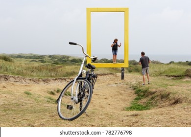 AMELAND DUTCH - 17SEP 2016.: Logo National Geographic Yellow Window On Island Ameland, Netherlands. View Through Frame. Location - National Protected Area OERD. Wadden Sea And People. 