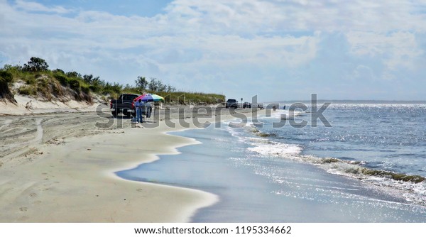 AMELIA ISLAND, FLORIDA, US - OCTOBER 22th, 2017:\
Beach-life on the Amelia island on October 22, 2017. People often\
come by car to the beaches to fishing, take some sunbathe and swim\
in the Atlantic 